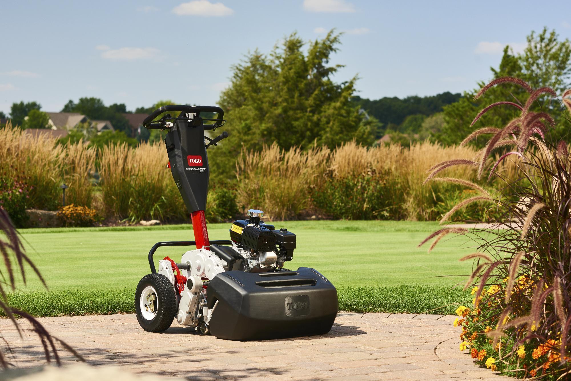 Toro Greensmaster 1021 stationary in front of a freshly cut golf course.