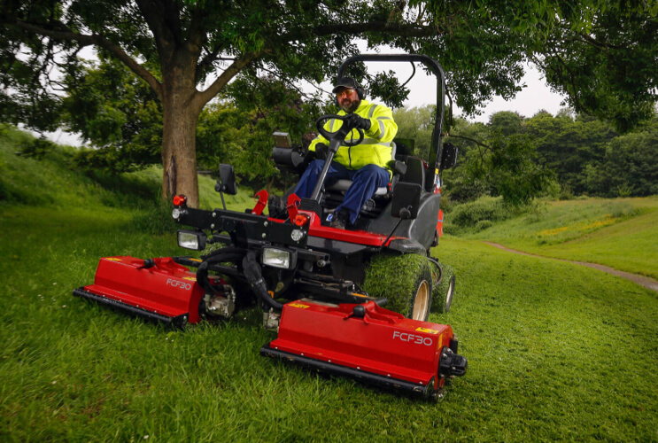 The Toro LT-F3000 cutting grass on a slope.