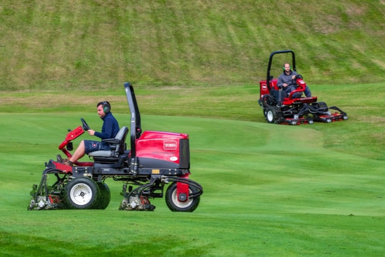 Toro Reelmaster 3575-D cutting a golf course with another Toro mower in the background.