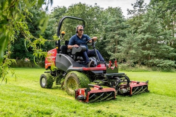 A CGM Group groundskeeper operating a Toro LT3340 mower.