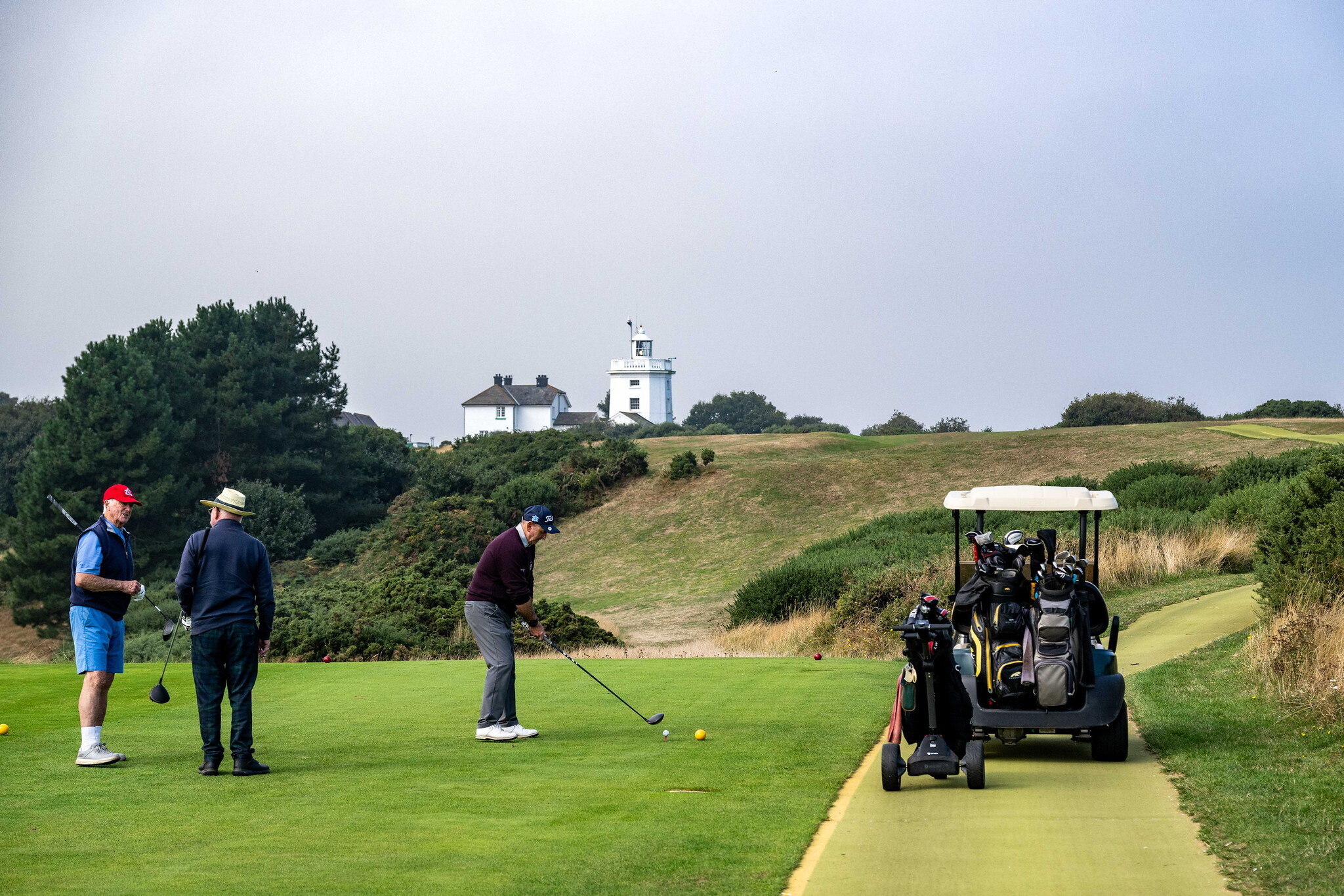 Elderly men playing golf