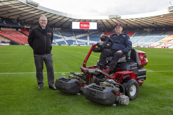 Stephen Bache, Head Groundsman at Hampden Park, right, with the Toro Greensmaster eTriFlex 3370, and Reesink’s Mike Turnbull.