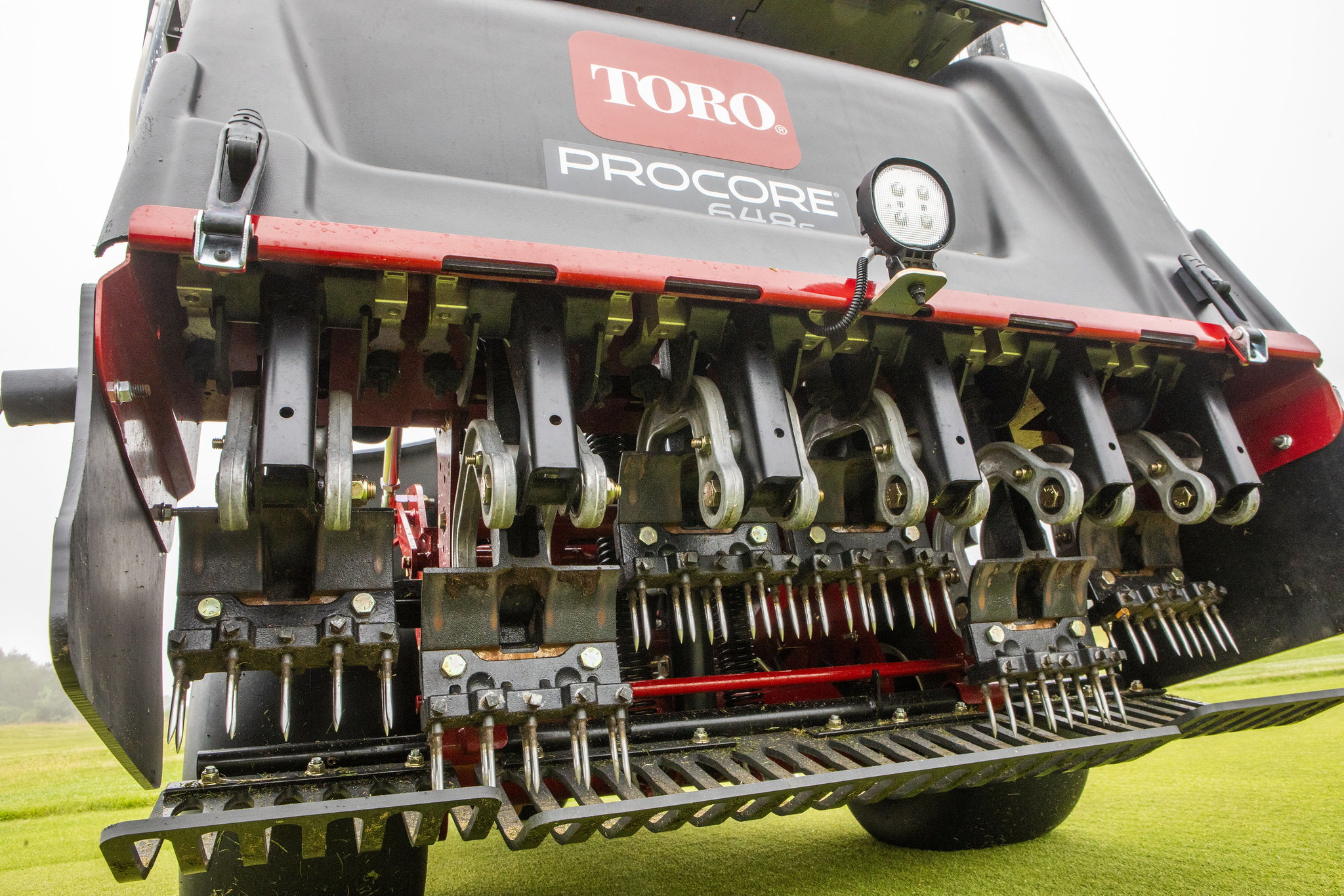 Close up of the tines of a Toro ProCore aerator